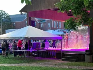 Crowd gathered at an outdoor stage under purple lights during Chautauqua Festival in Wytheville