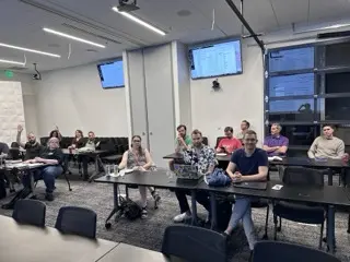 Audience seated at tables during an AI meetup at Vaco in the Nashville area